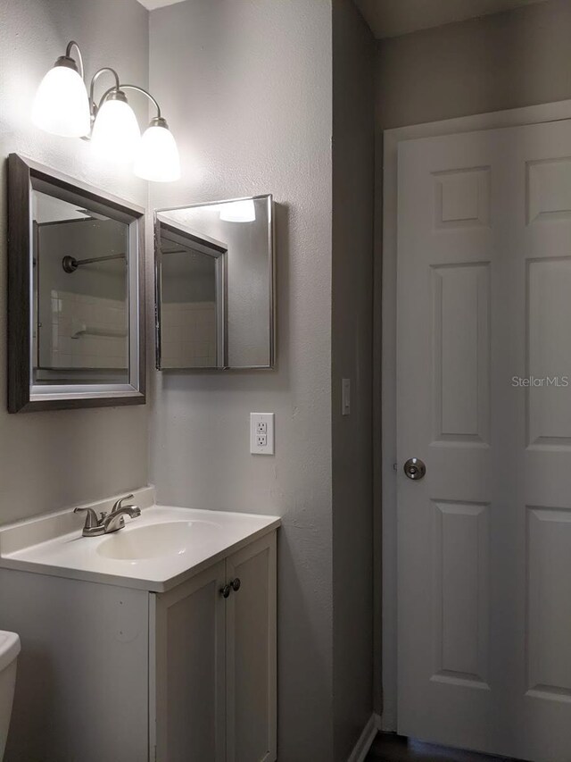 bathroom featuring vanity and toilet