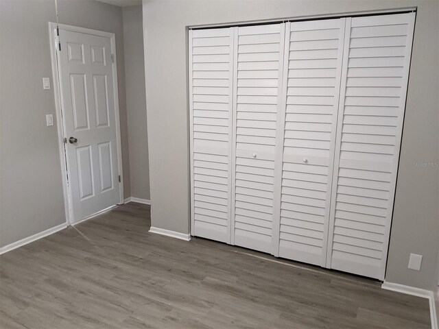 unfurnished bedroom with light hardwood / wood-style floors and a closet