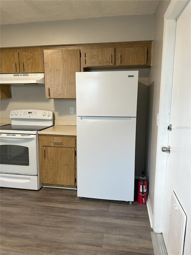 kitchen with a textured ceiling, dark wood-type flooring, and white appliances