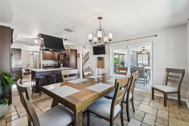 dining room with a textured ceiling and a chandelier