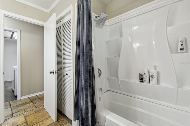 bathroom with ornamental molding and shower / bathtub combination with curtain