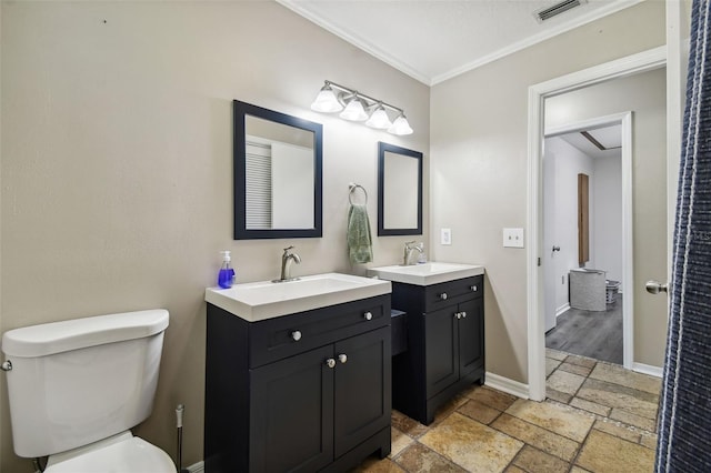 bathroom with ornamental molding, toilet, and vanity