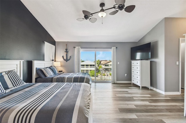 bedroom with ceiling fan, vaulted ceiling, light hardwood / wood-style flooring, and access to exterior