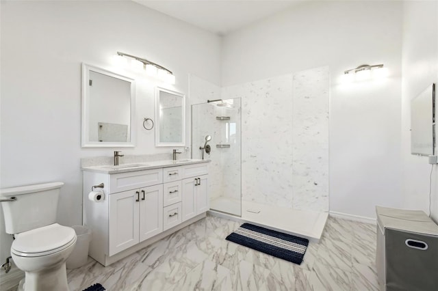 bathroom featuring vanity, toilet, and tiled shower