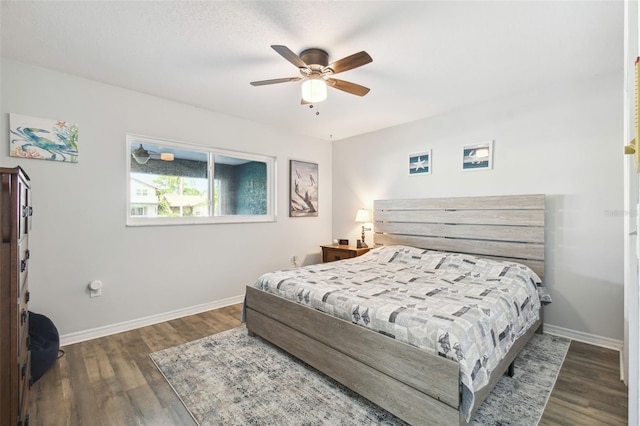 bedroom with ceiling fan and dark hardwood / wood-style floors