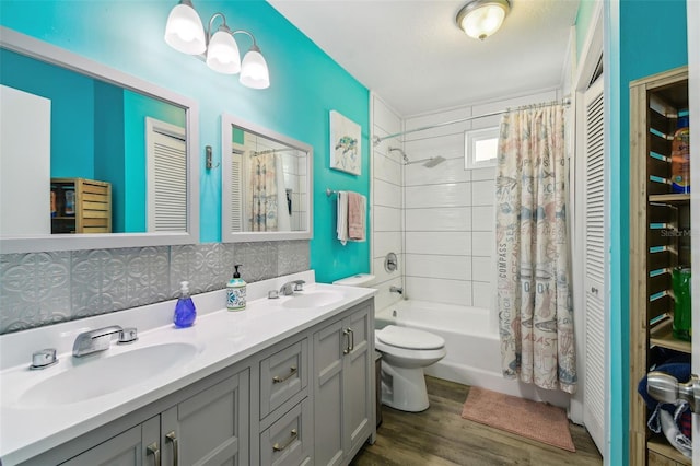 full bathroom with vanity, hardwood / wood-style floors, shower / bathtub combination with curtain, toilet, and decorative backsplash