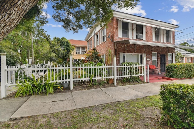 view of front of property featuring cooling unit and a porch