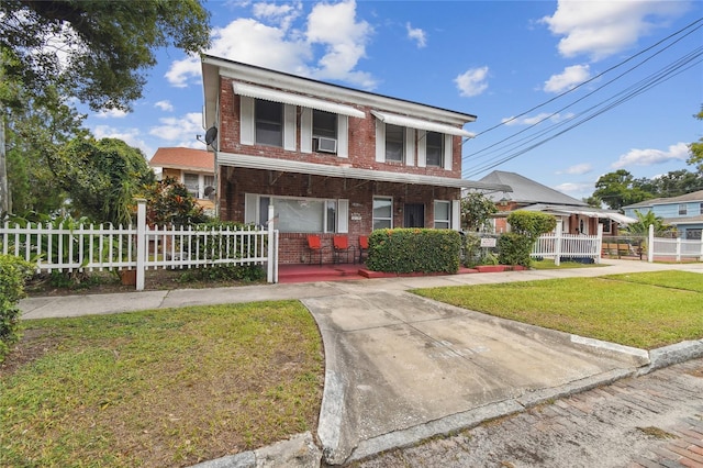 view of front facade featuring cooling unit, a front lawn, and a porch