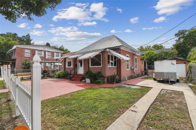 bungalow-style house featuring a front yard