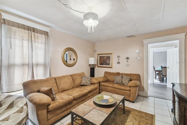 living room with light tile patterned floors and a chandelier