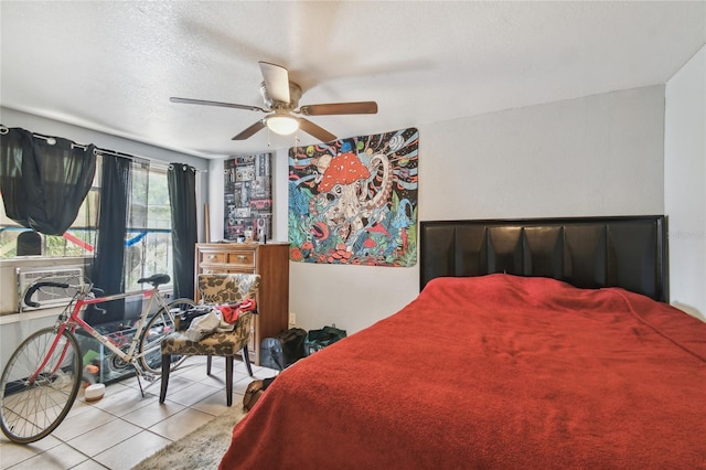 tiled bedroom featuring cooling unit, ceiling fan, and a textured ceiling