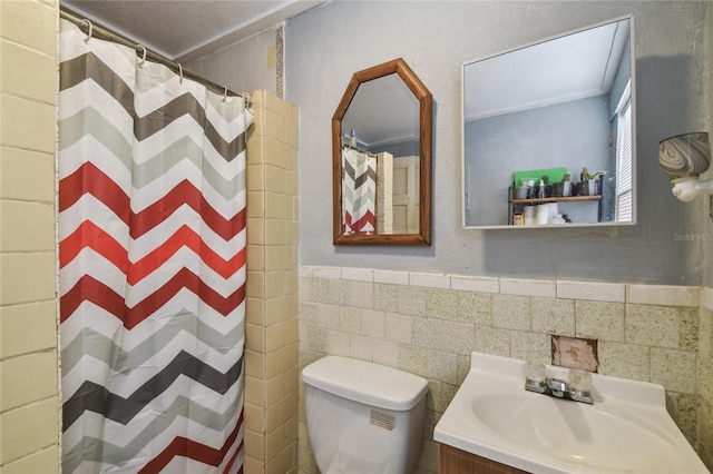 full bath with a wainscoted wall, tile walls, curtained shower, toilet, and vanity