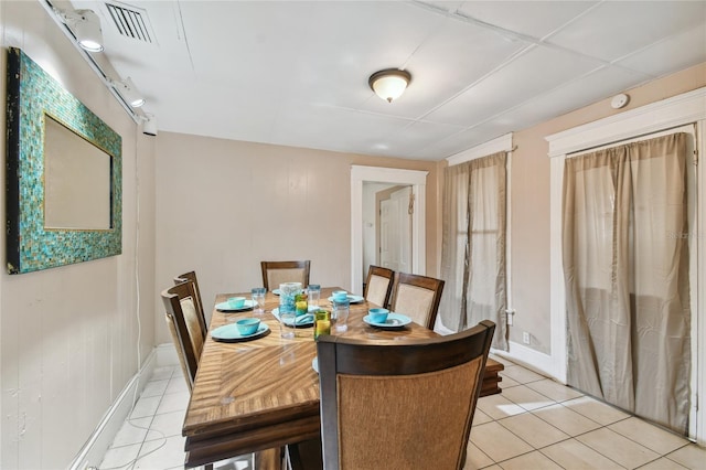 dining space with light tile patterned floors, visible vents, and baseboards