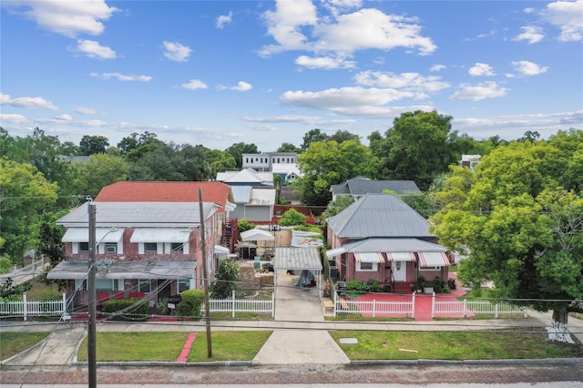 exterior space with a fenced front yard and concrete driveway