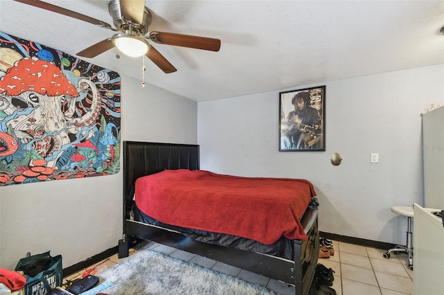 bedroom featuring baseboards, a ceiling fan, and tile patterned floors