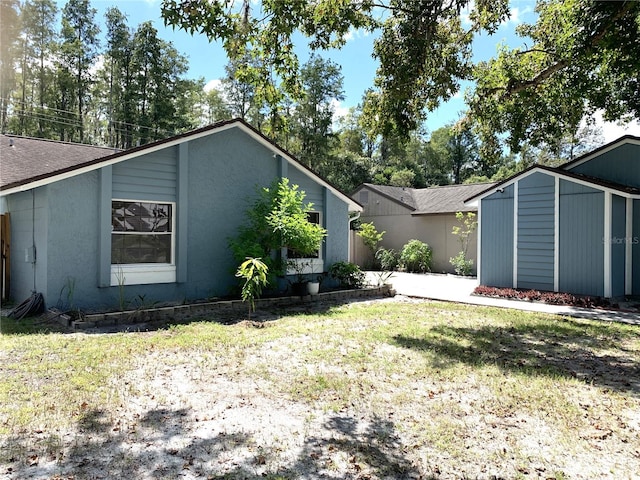 exterior space with a yard and a storage unit