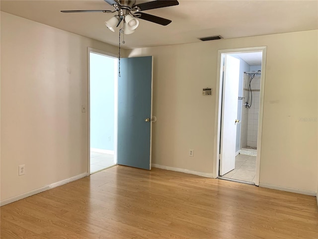 spare room featuring ceiling fan and light hardwood / wood-style flooring