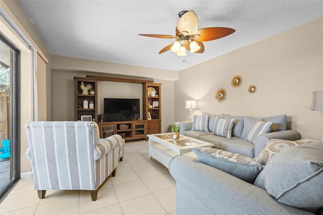 tiled living room with ceiling fan and a textured ceiling