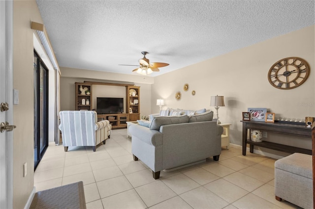 tiled living room with ceiling fan and a textured ceiling