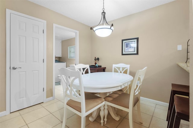 dining room featuring separate washer and dryer and light tile patterned floors