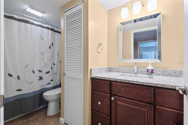 bathroom featuring tile patterned flooring, vanity, and toilet