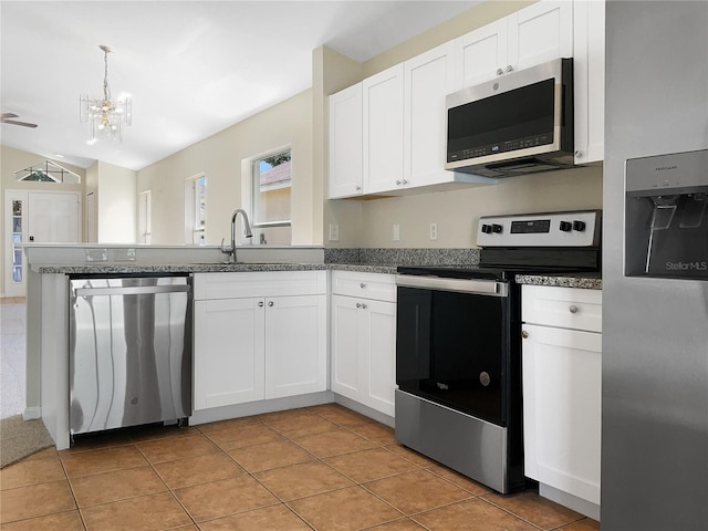 kitchen with light tile patterned floors, appliances with stainless steel finishes, sink, and white cabinets