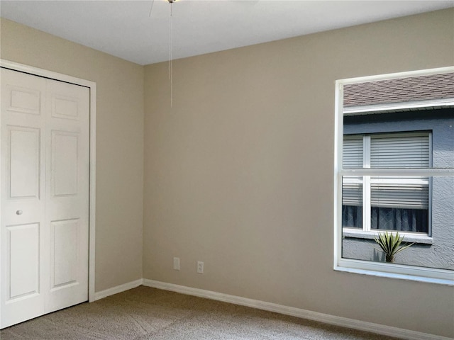 unfurnished bedroom featuring carpet floors and a closet