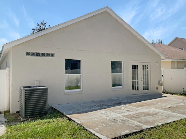 rear view of house featuring a patio, central AC unit, and french doors