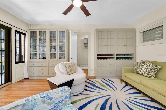 living room featuring light hardwood / wood-style floors and ceiling fan