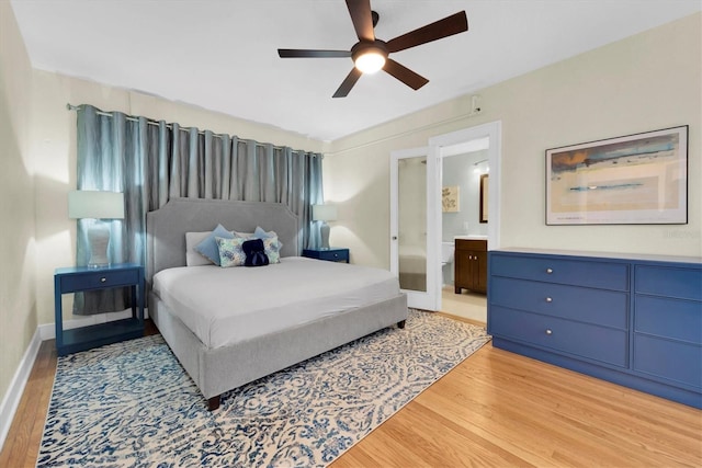 bedroom featuring light hardwood / wood-style flooring, ceiling fan, and ensuite bathroom