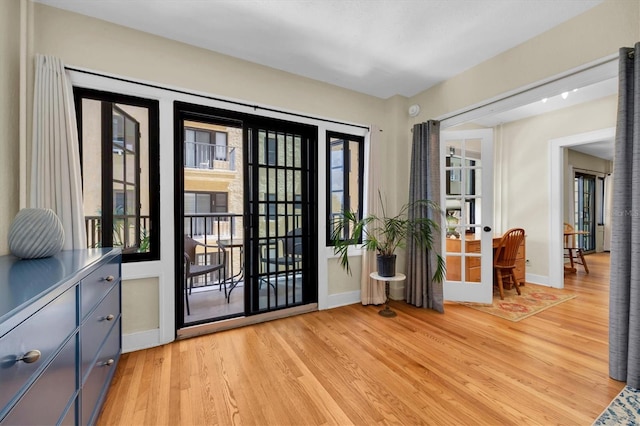 entryway featuring light wood-type flooring and french doors