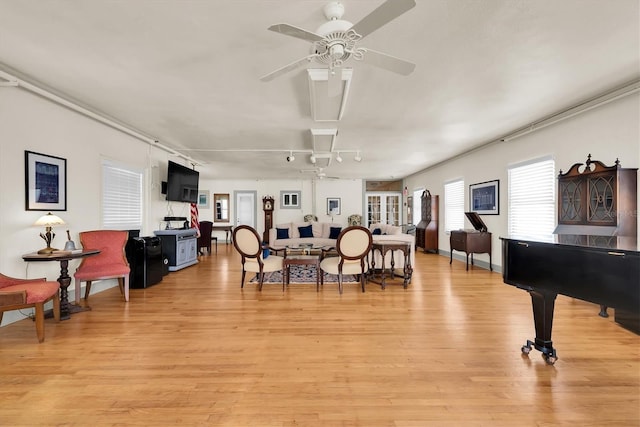 dining area featuring light wood-type flooring, ceiling fan, and rail lighting