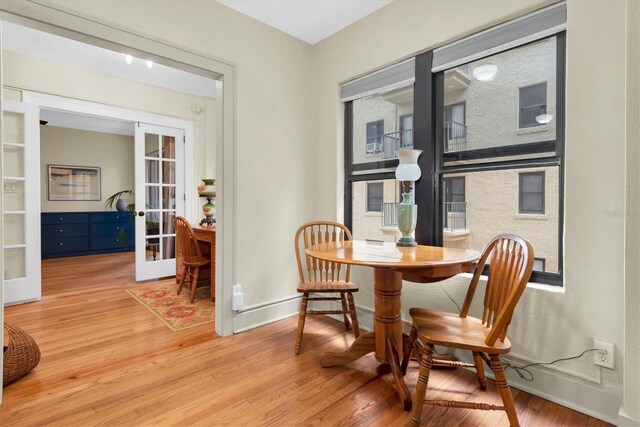 dining room featuring light wood-type flooring and french doors