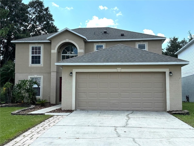 traditional-style house featuring a shingled roof, stucco siding, concrete driveway, a front lawn, and a garage