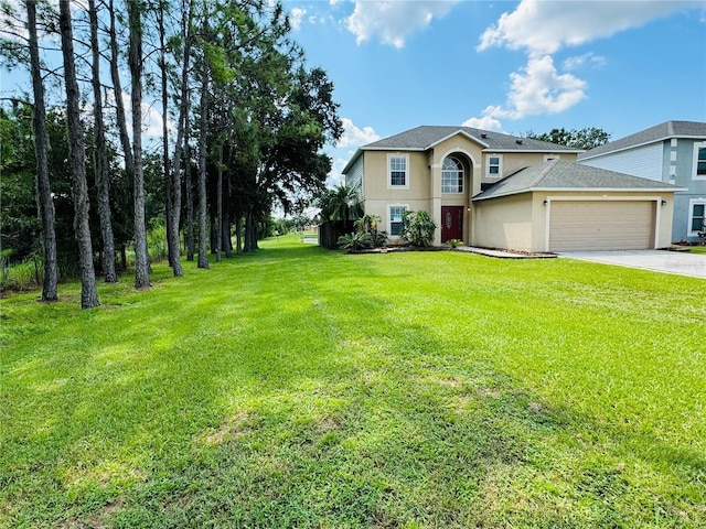 traditional home featuring driveway, an attached garage, a shingled roof, stucco siding, and a front lawn