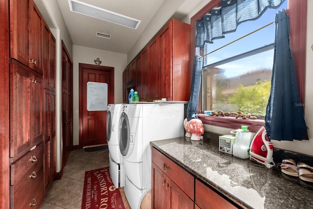 laundry room featuring light tile patterned floors, independent washer and dryer, and cabinets