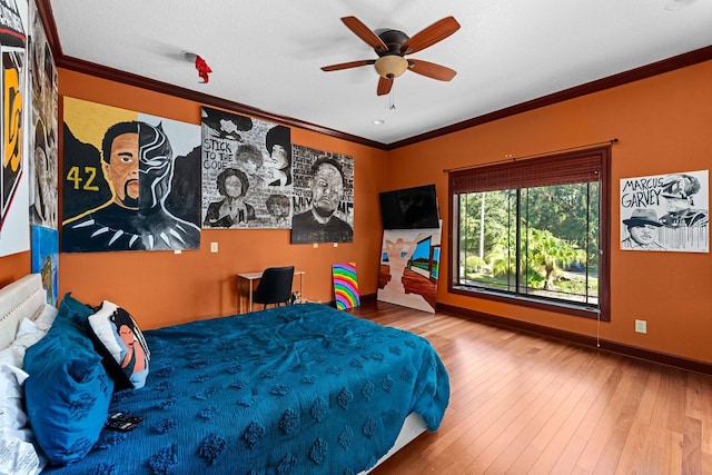 bedroom featuring ceiling fan, hardwood / wood-style flooring, and crown molding