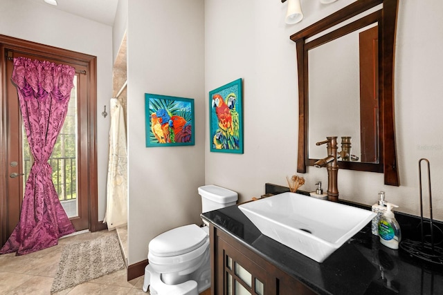 bathroom with tile patterned flooring, curtained shower, vanity, and toilet