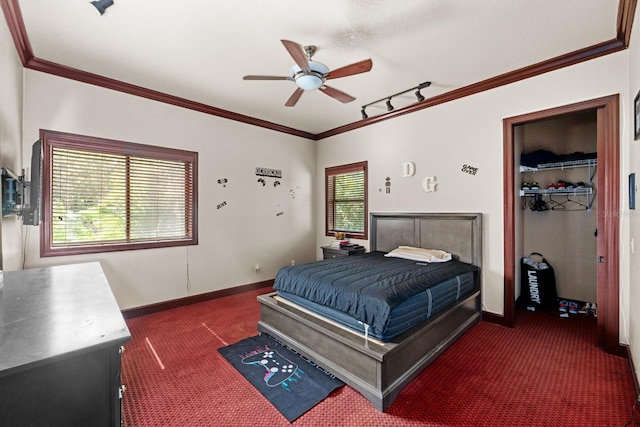 carpeted bedroom featuring ceiling fan, a closet, and ornamental molding