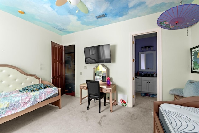 carpeted bedroom with ceiling fan and ensuite bathroom