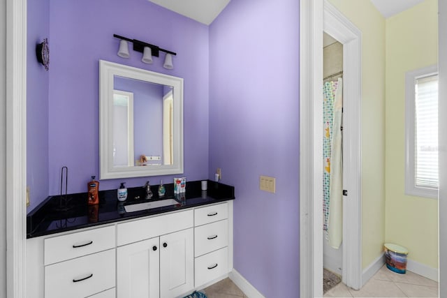 bathroom with tile patterned flooring and vanity