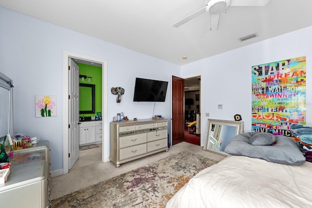 bedroom with light carpet, ceiling fan, and ensuite bathroom