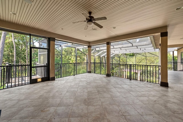 unfurnished sunroom featuring wooden ceiling and ceiling fan