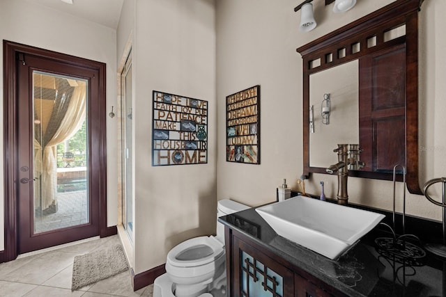 bathroom with tile patterned floors, an enclosed shower, vanity, and toilet