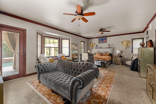 living room featuring a textured ceiling, ornamental molding, light carpet, and ceiling fan