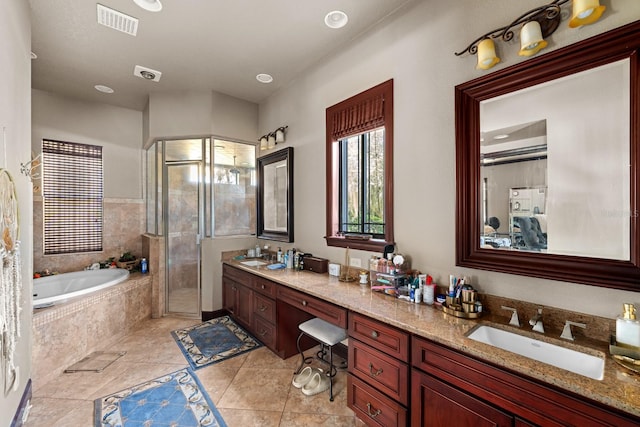 bathroom featuring tile patterned floors, independent shower and bath, and vanity