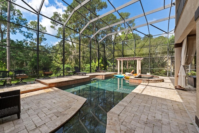 view of swimming pool featuring glass enclosure, an in ground hot tub, and a patio area