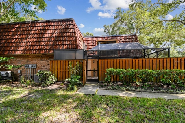 view of yard with glass enclosure