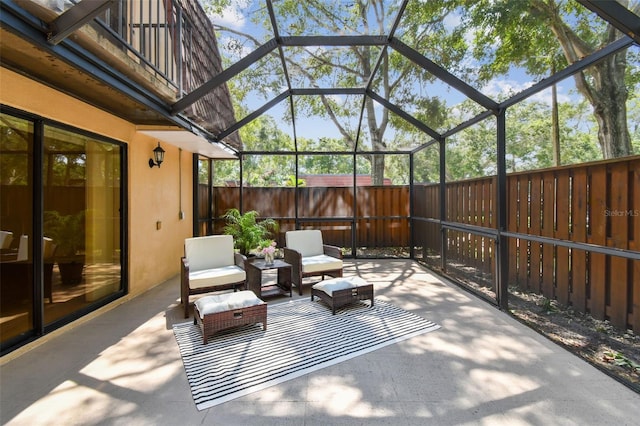 view of patio with glass enclosure