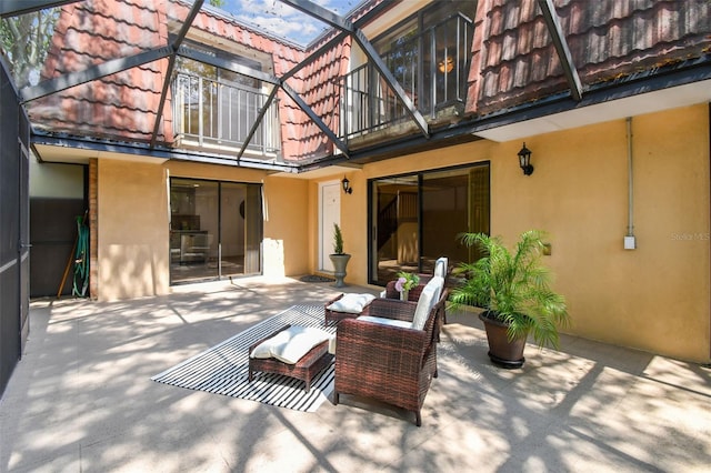 rear view of house featuring a patio and a balcony